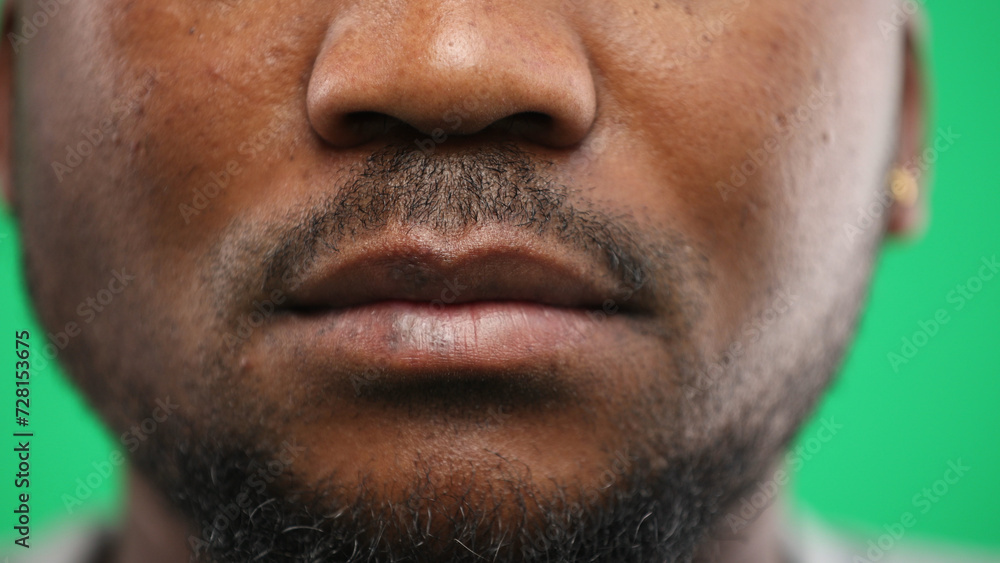 Obraz premium Man's mouth, close-up, on a green background