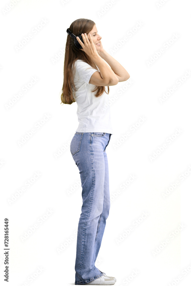 A woman, full-length, on a white background, wearing headphones A woman, full-length, on a white background, wearing headphones