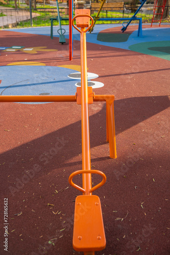 perspective of a colorful seesaw on a children's playground