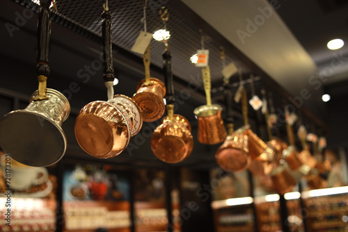 Photography Kitchenware pots and jugs hanging from the ceiling in the cafe