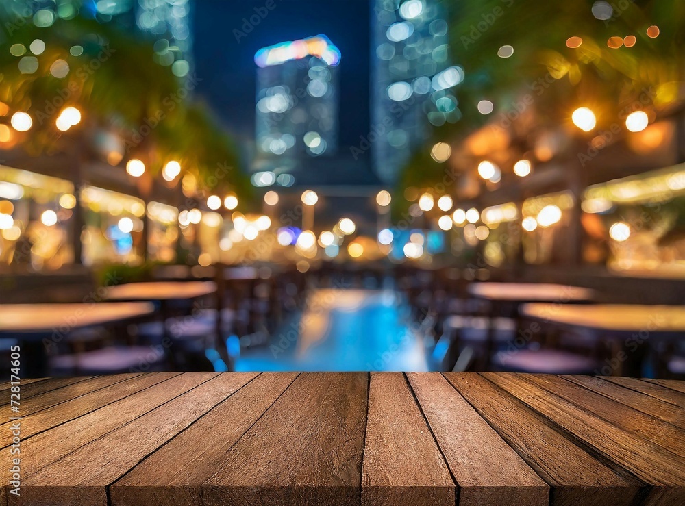 Empty wooden table top with blur background of restaurant at night