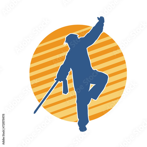 Silhouette of a kungfu or wushu martial art athlete in action pose. Silhouette of a male martial art person in pose with swords weapon.
