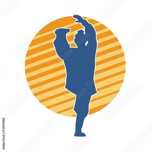 Silhouette of a man in oriental martial art pose. Silhouette of a male in martial art move.