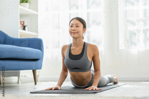 Wellness Attractive Asian woman practice yoga Cobra pose at home to meditation comfortable and relax,Calm of healthy young woman deep breath and meditation with yoga at home,Yoga Concept