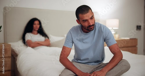Couple, conflict and man with stress in home with fight about marriage, divorce or depression. Partner, thinking and anxiety with woman in bedroom from erectile dysfunction or problem in relationship photo