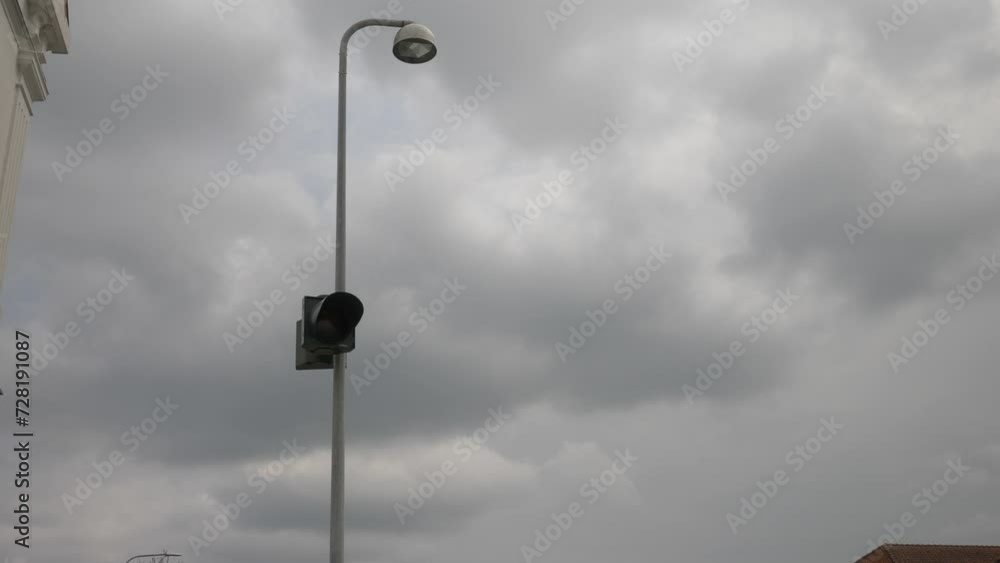Street light flashes orange in cloudy weather. Street light flashes orange in cloudy weather.