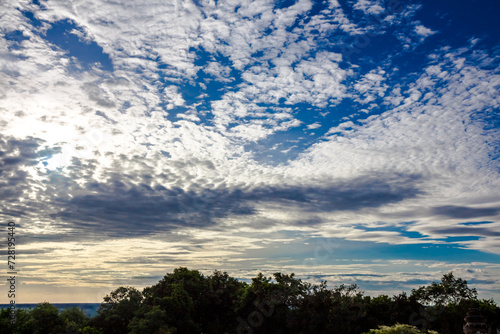 Panoramic cloudscape with the sun rays radiating from behind the cloud.Phnom Bakheng sunset view Angkor Wat, Siem Reap, Cambodia