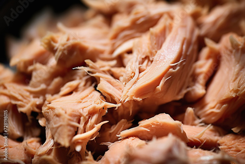 Canned tuna shredded closeup. Texture of flaked tuna photo