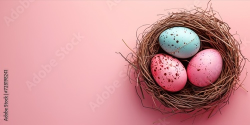 Easter eggs in the straw nest with pink background. Happy easter day background concept.
