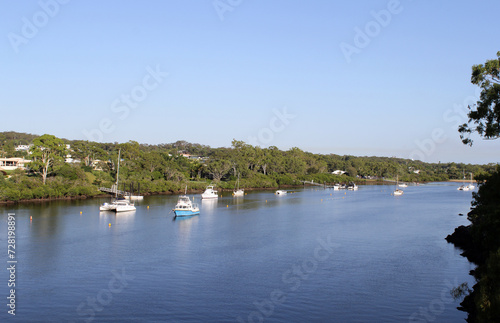 Serene view of the Boyne River with boats and trees in Boyne Island/Tannum Sands in Queensland, Australia