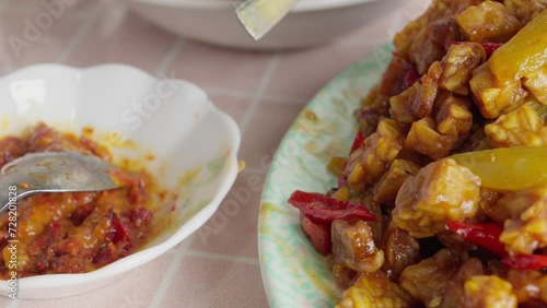 Close-up of Indonesian tempeh orek with sambal on a table, vibrant colors, traditional cuisine photo