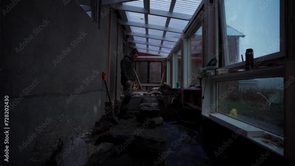 Person Piling Up Crushed Big Rocks On The Ground Of A DIY Backyard Hothouse. Timelapse Person Piling Up Crushed Big Rocks On The Ground Of A DIY Backyard Hothouse. Timelapse