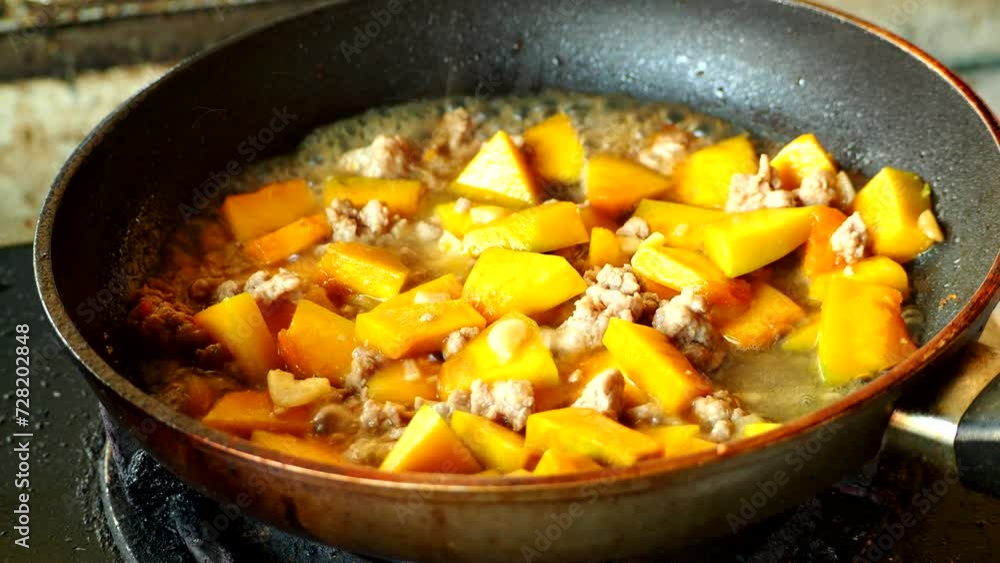 Frying chopped pumpkin with minced pork in pan, in door Chiangmai Thailand. Frying chopped pumpkin with minced pork in pan, in door Chiangmai Thailand.