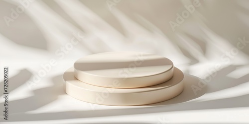 Empty round pastel beige platform podium on white background with natural light and shadows. Mock up background for cosmetic product presentation. Top view