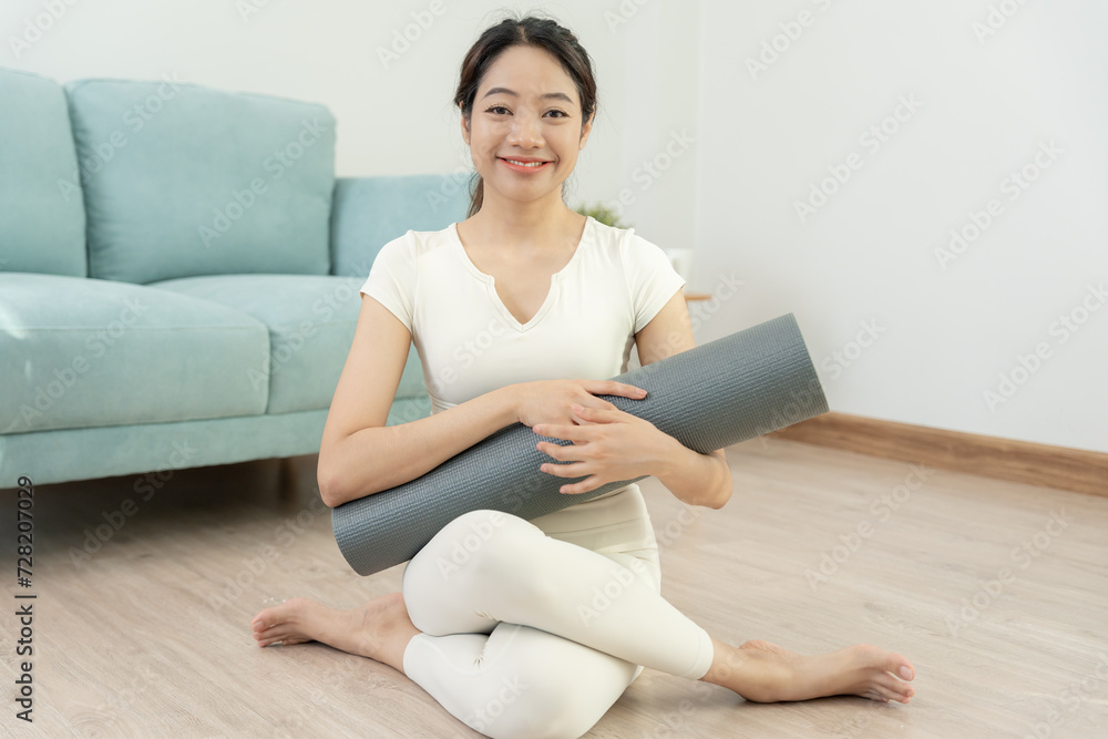 Portrait Slim asian woman smile after yoga at home. Asian woman doing exercises in morning. balance, meditation, relaxation, calm, good health, happy, relax, healthy lifestyle, diet, slim
