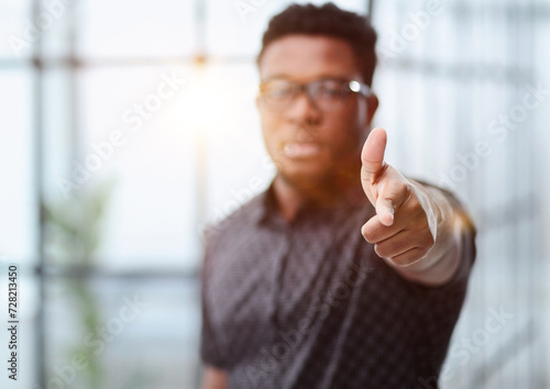 serious black businessman in glasses pointing at you