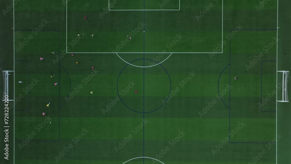 Aerial Drone, green soccer field seen from above rising, players in a match, lines of play Aerial Drone, green soccer field seen from above rising, players in a match, lines of play