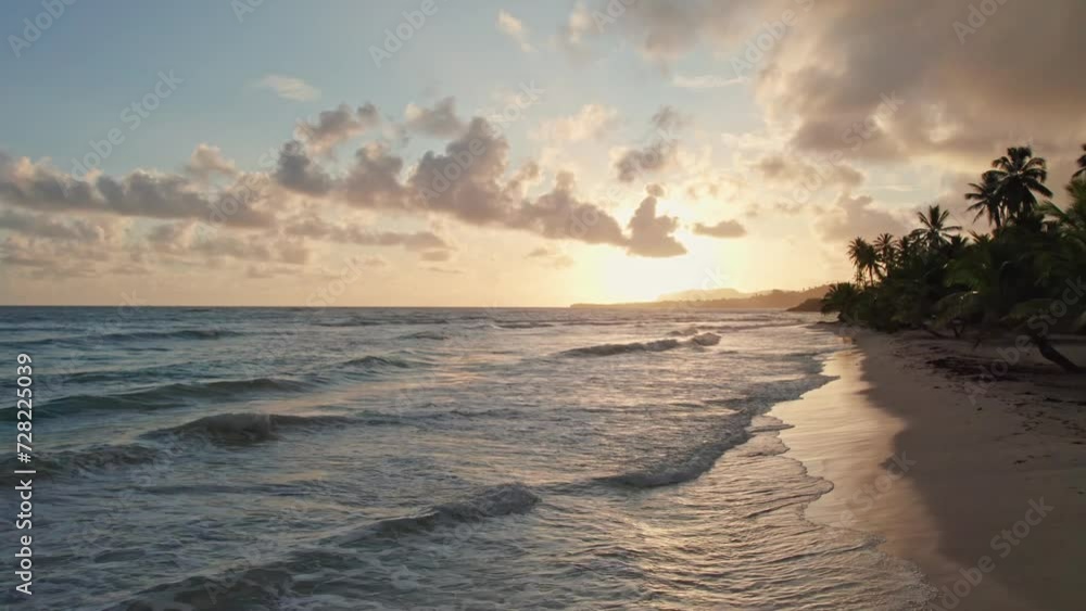 Cinematic sunset on tropical beach. Aerial fying over waves Cinematic sunset on tropical beach. Aerial fying over waves