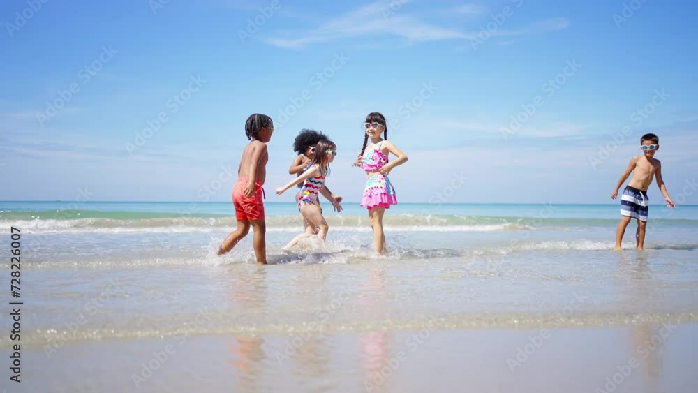 Happy children travel nature beach on summer holiday vacation. Group of Little cute child boy and girl kids enjoy and fun outdoor lifestyle running and playing water in the sea at tropical island. Happy children travel nature beach on summer holiday vacation. Group of Little cute child boy and girl kids enjoy and fun outdoor lifestyle running and playing water in the sea at tropical island.