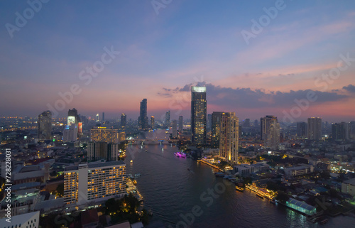 Aerial view of Bangkok Downtown Skyline with Chao Phraya River, Thailand. Financial district and business centers in smart urban city in Asia. Skyscraper and high-rise buildings.