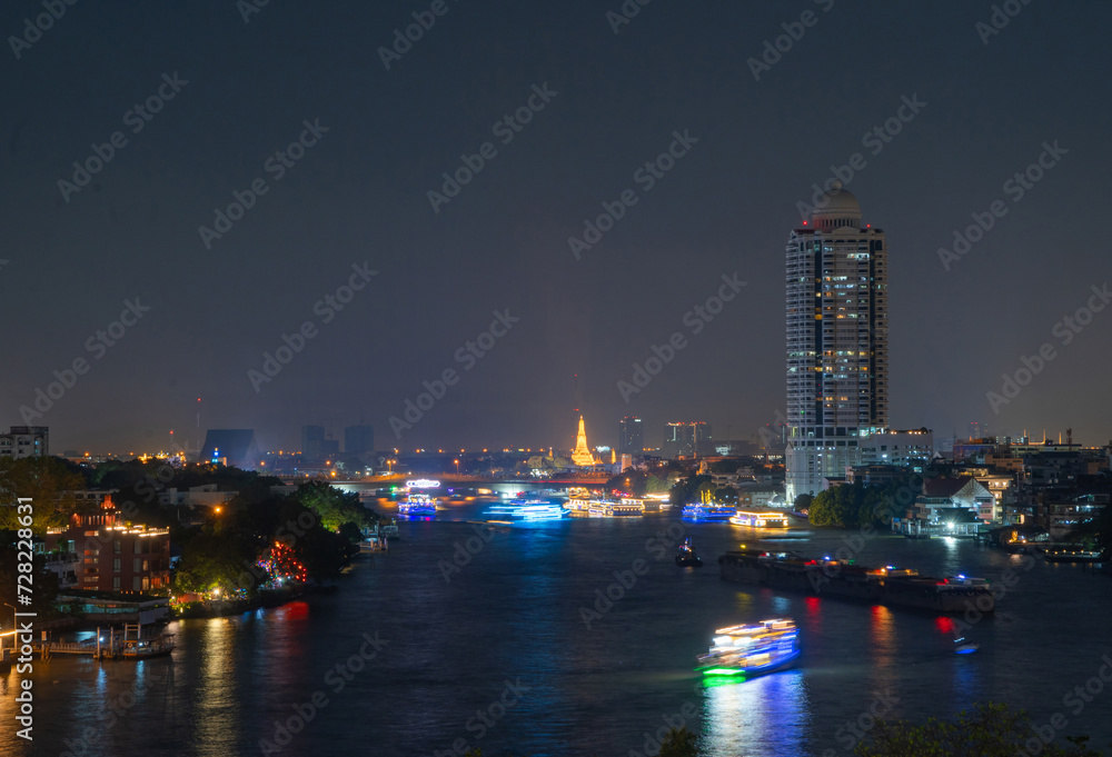 Aerial top view of Temple of Dawn or Wat Arun with urban city town in Rattanakosin Island in architecture, Urban old town city, Bangkok skyline. downtown area, Thailand.