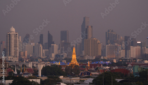 Aerial top view of Temple of Dawn or Wat Arun with urban city town in Rattanakosin Island in architecture, Urban old town city, Bangkok skyline. downtown area, Thailand.