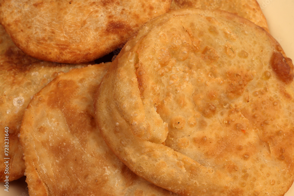Deep fried stuffed pancakes aloo dal puri Bengali snacks on enamel tin