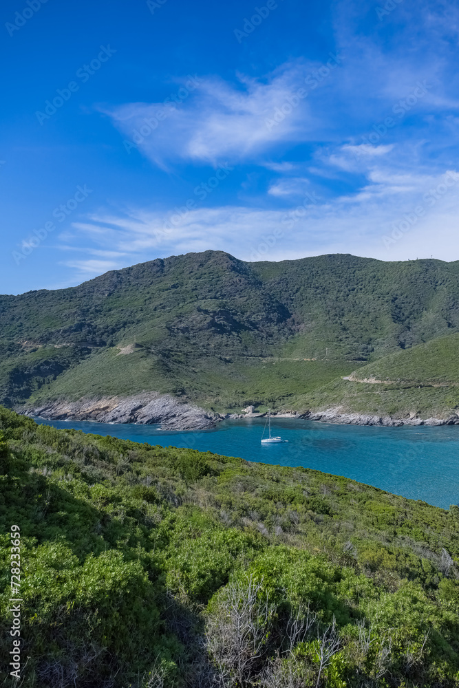 Corsica, seascape in the cap Corse, a beautiful creek with a boat, transparent water,  in summer
