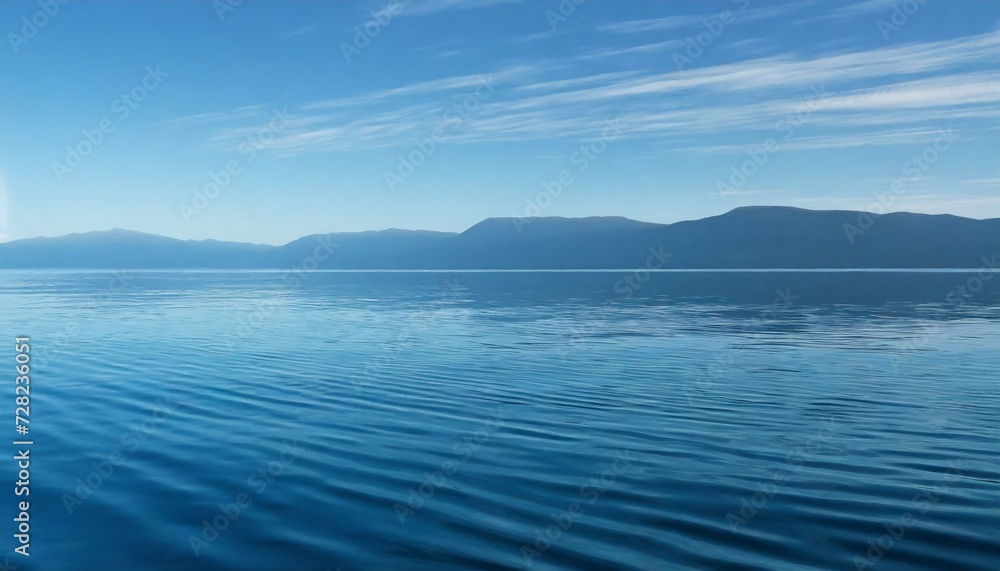 Calm waves of the sea under a blue sky. 