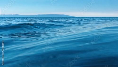 Calm waves of the sea under a blue sky. 