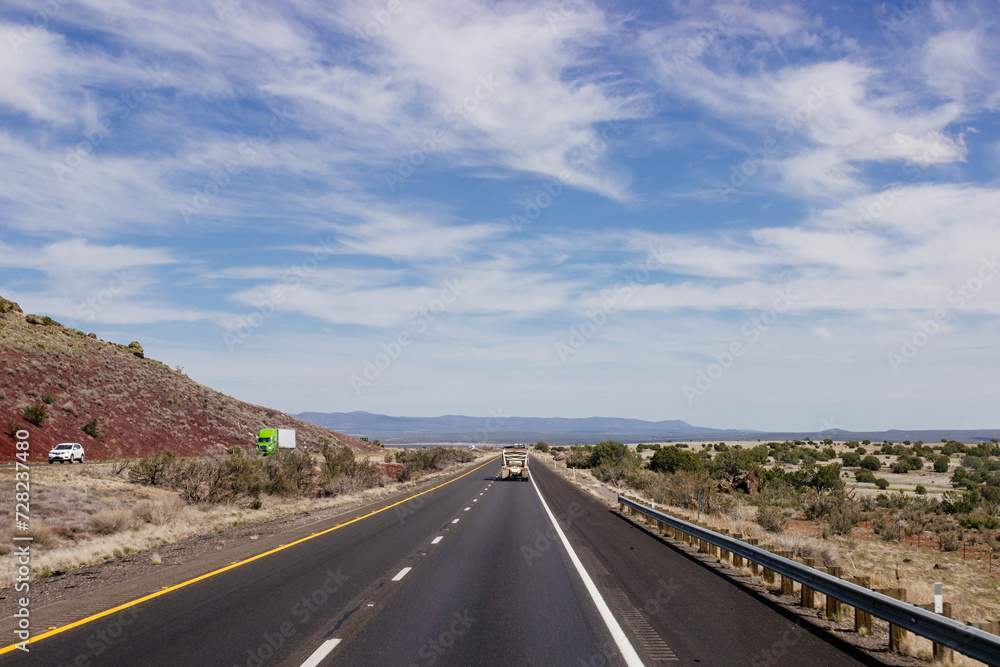 Beautiful blue sky with fluffy clouds over the highway. Scenic road in Arizona, USA on a sunny summer day. 40 hwy, 10 hwy in Arizona, USA - 17 April 2020 Beautiful blue sky with fluffy clouds over the highway. Scenic road in Arizona, USA on a sunny summer day. 40 hwy, 10 hwy in Arizona, USA - 17 April 2020