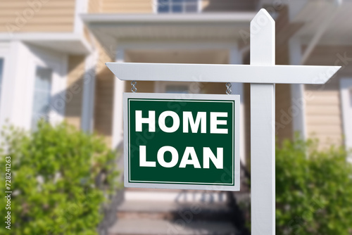 HOME LOAN sign against a house. Close-up.