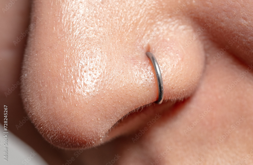 Fototapeta premium Close-up of a nose piercing. Macro