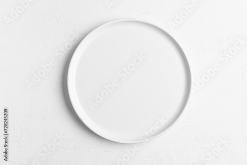 Empty white plate on white table