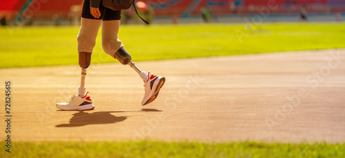 Paralympic runner wearing prosthetic leg on track and field Walk and get ready photo