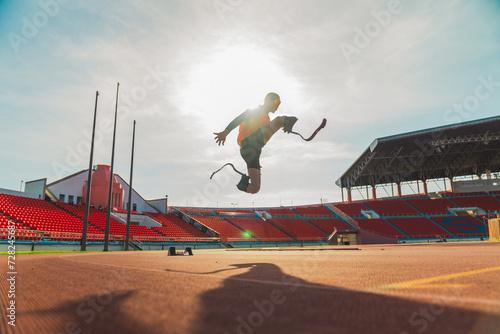 Asian para-athlete runner inspiration prosthetic leg on the track alone outside on a stadium track Paralympic running concept.