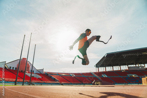 Asian para-athlete runner inspiration prosthetic leg on the track alone outside on a stadium track Paralympic running concept.