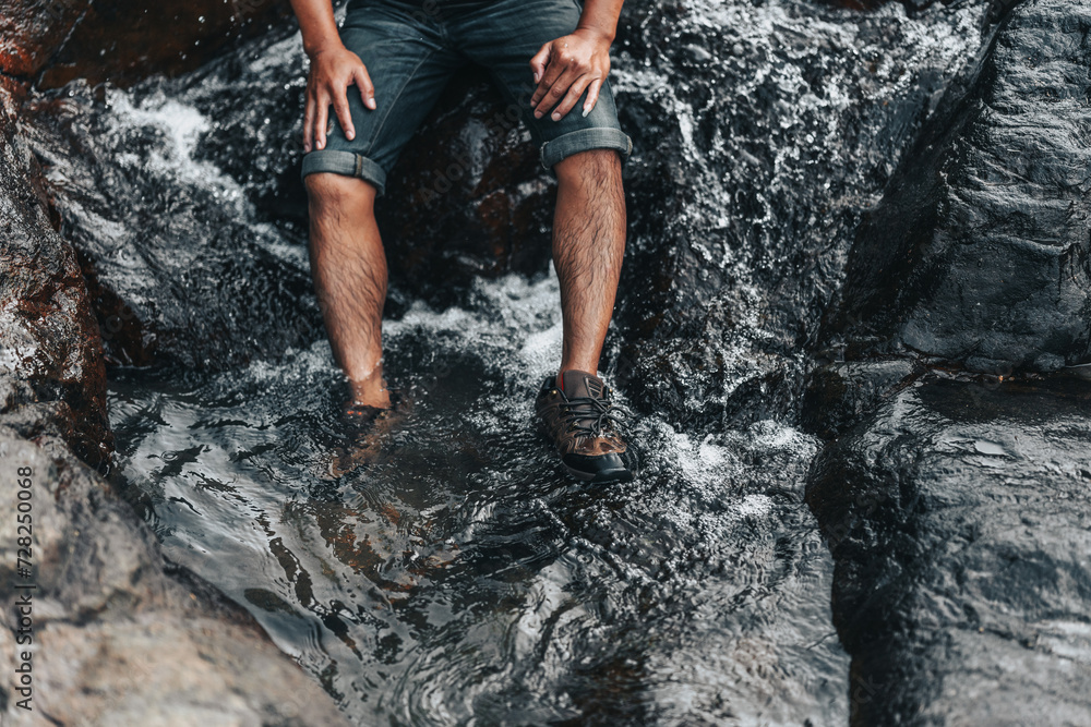 Hikers relax in the stream flowing from the waterfall. hiking concept.