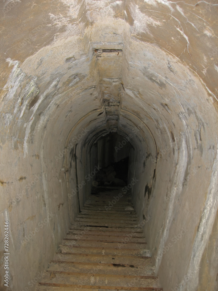 Going down by Dark narrow concrete underpass, underground Stone tunnel Inside the Vladivostok fortress Fort 9