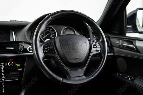 Modern car interior steering wheel controls © Harry