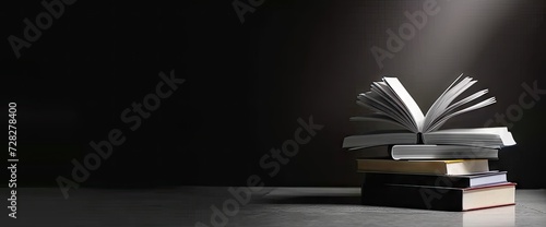 Pile of open books against backdrop of hand with ample space for text symbolizing pursuit of education and knowledge scene set in realm of literature and learning old pages and vintage texts photo