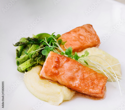 salmon steaks with mashed potatoes on white plate