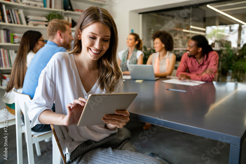 Quadro em tela Smiling diverse colleagues gather in boardroom brainstorm discuss financial stat