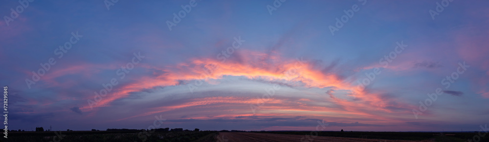 Amazing wide sunset panorama in a beautiful summer evening.	
