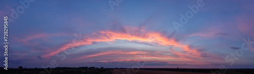 Amazing wide sunset panorama in a beautiful summer evening. 