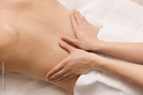 Woman receiving back massage on couch in spa salon  top view