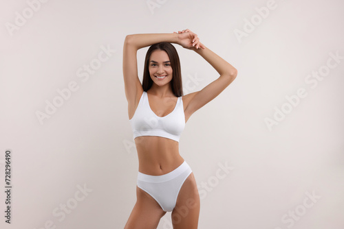 Young woman in stylish bikini on white background © New Africa