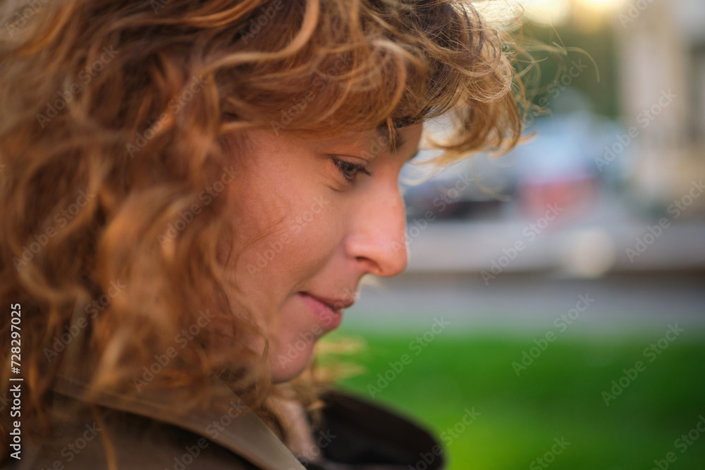 Portrait of happy mature woman looking at camera. Successful proud woman in city street at sunset. Satisfied Caucasian woman in formal clothing smiling outdoors. High quality photo Portrait of happy mature woman looking at camera. Successful proud woman in city street at sunset. Satisfied Caucasian woman in formal clothing smiling outdoors. High quality photo