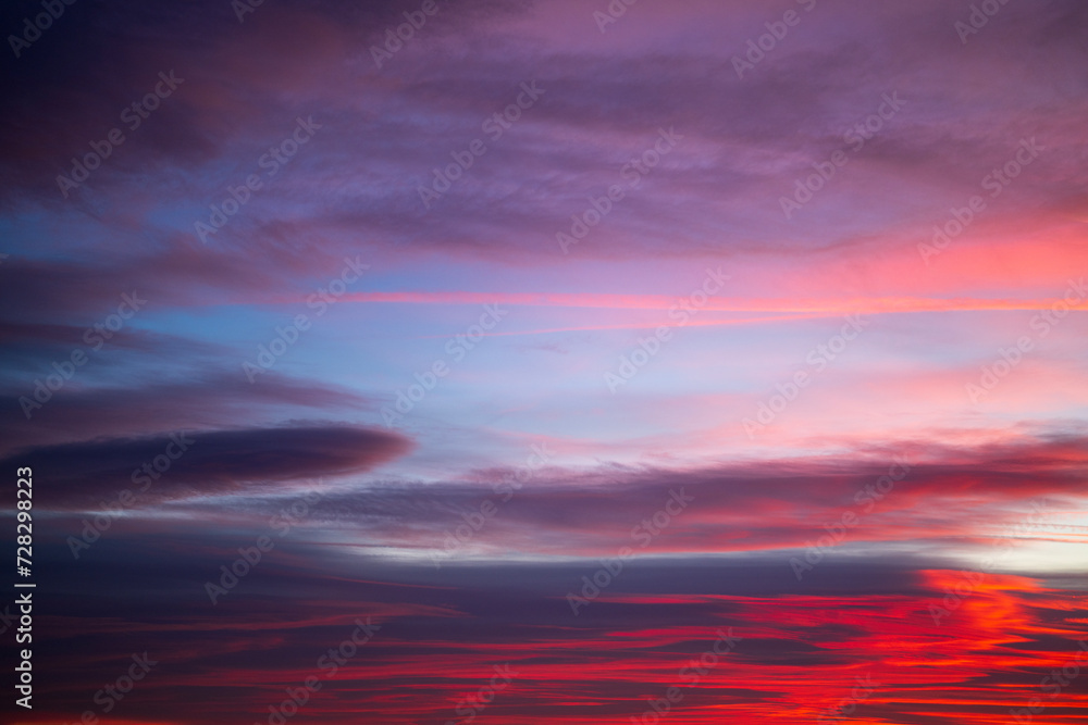 Dramatic clouds on a bright sunset sky. Natural background.