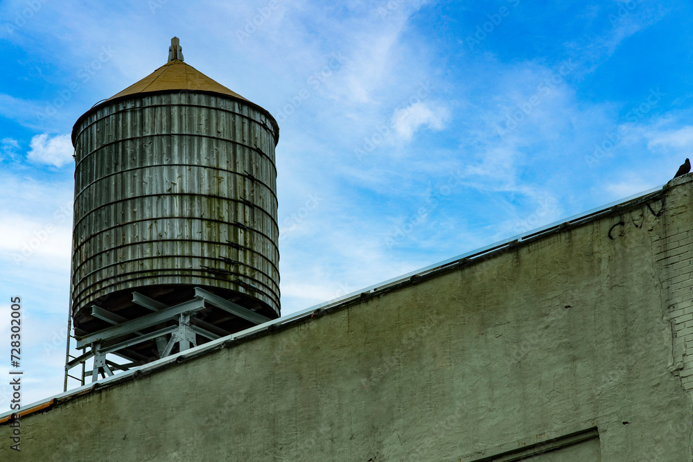 Typical wooden water tank on the roofs of New York City (USA), this is a typical scenario of the United States of America. Typical wooden water tank on the roofs of New York City (USA), this is a typical scenario of the United States of America.